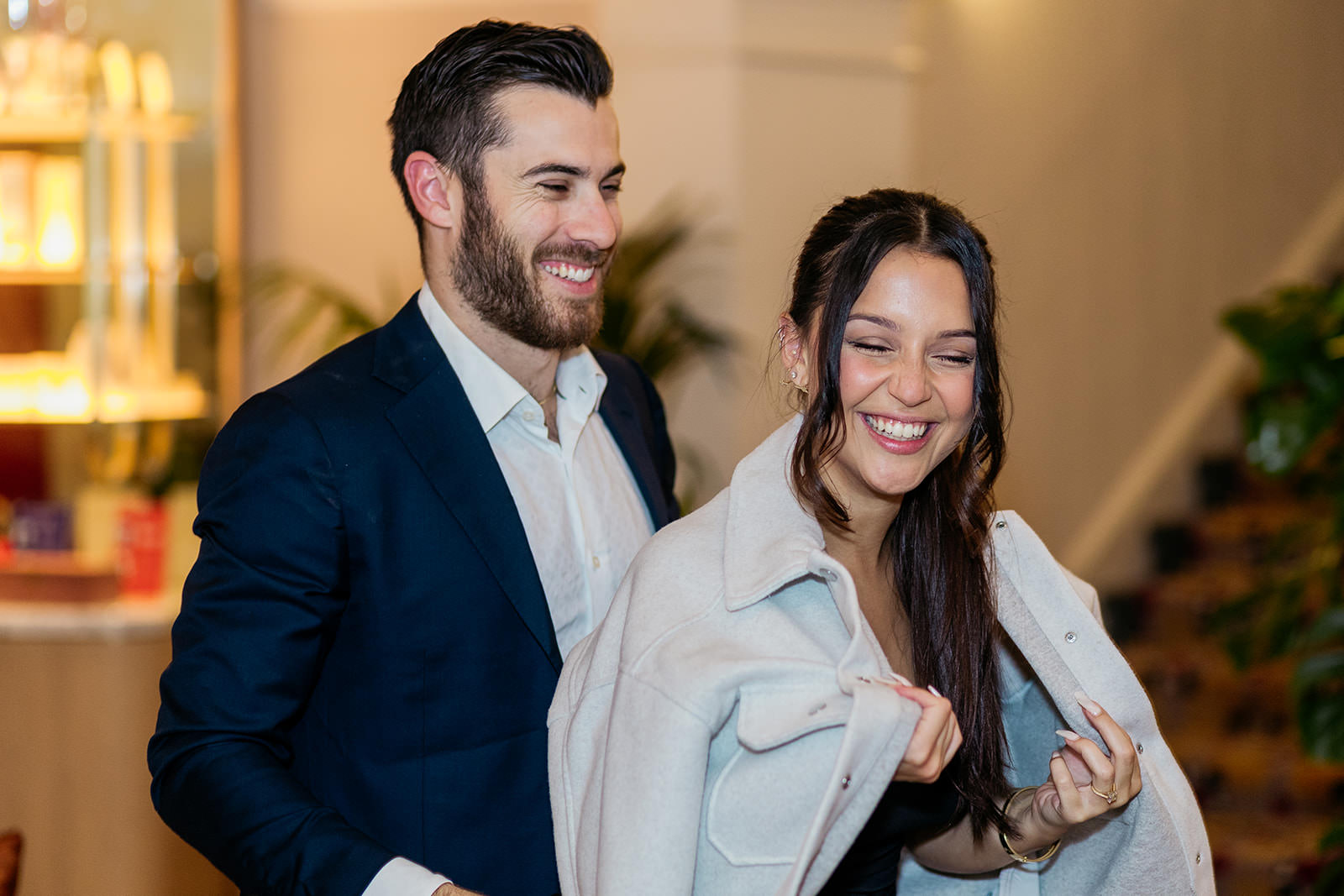 man-puts-jacket-round-his-fiances-shoulders-and-they-are-smiling