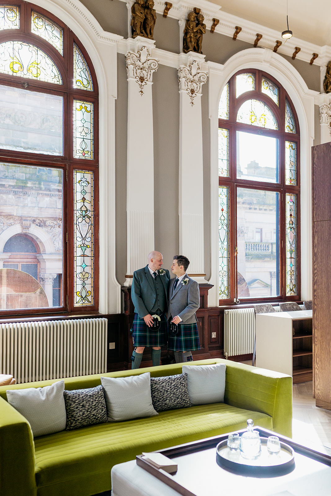 a couple are standing in the Liberty Suite at the AC Hotel. they are looking at each other and smiling.