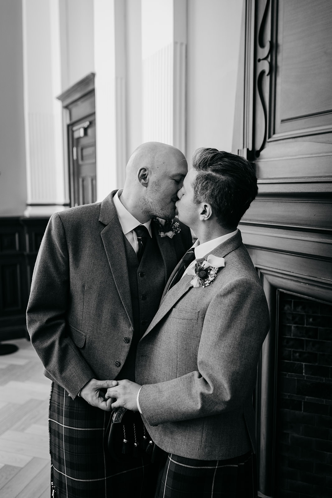 a married couple are facing each other and sharing a kiss.