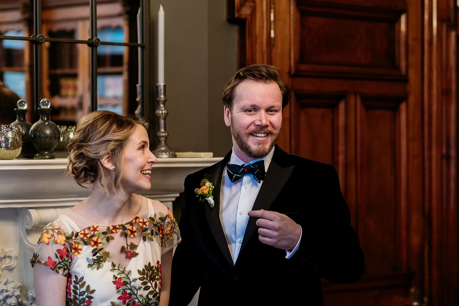 a couple are standing side by side and smiling.